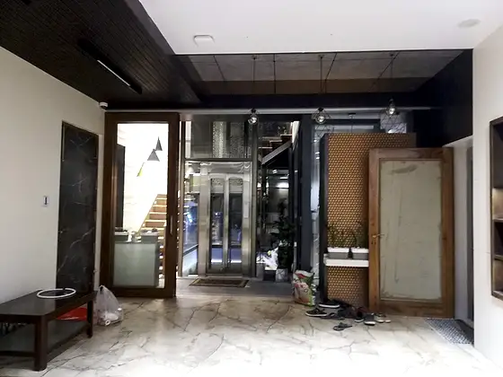 Glass lift and shaft seen from the stairs