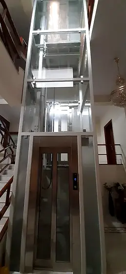 Glass lift and shaft seen from the stairs