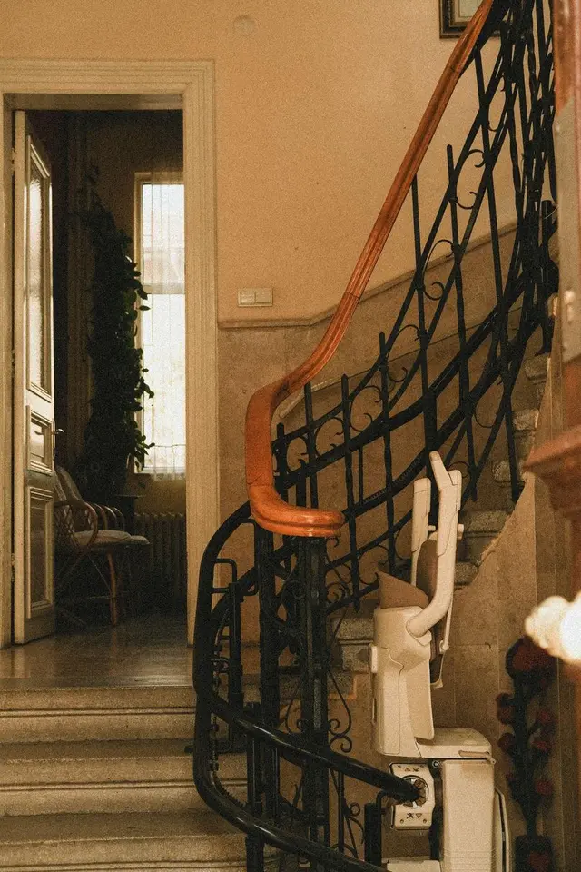 Stairlift chair on a track along a home staircase